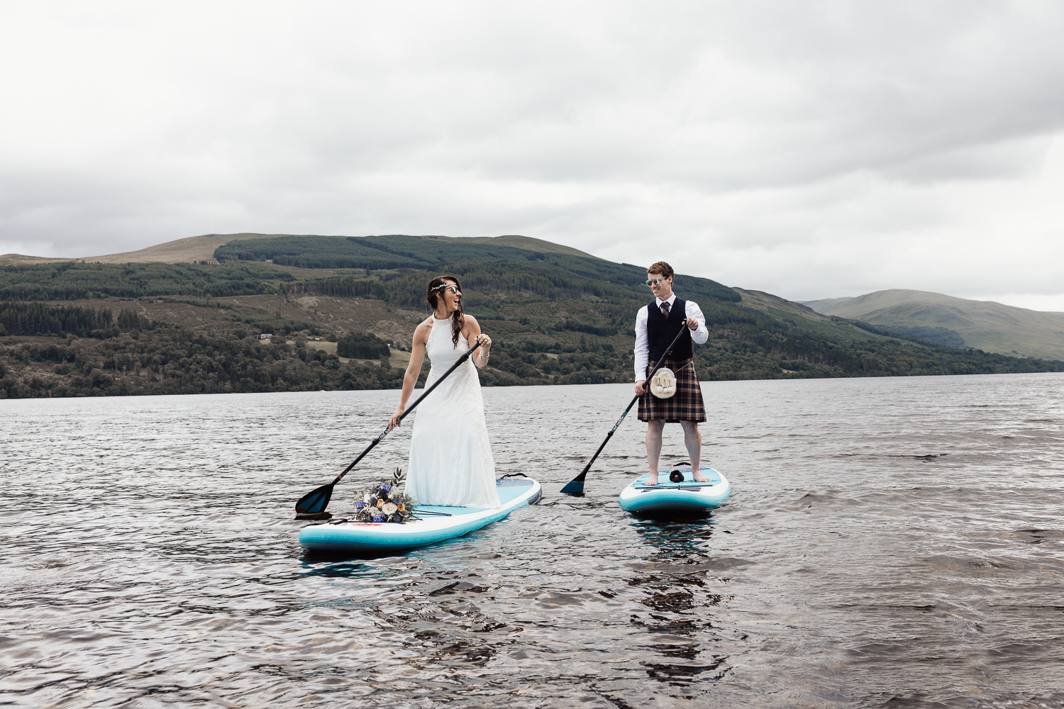 wedding couple paddle boarding on loch tay