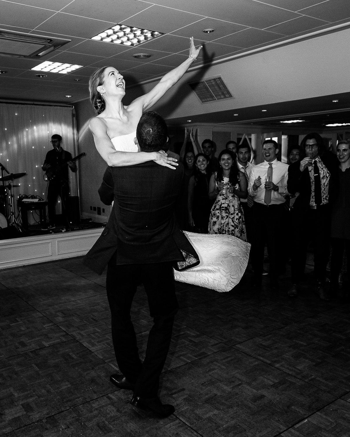 groom lifts bride during wedding couple first dance in the ferntower suite at crieff hydro