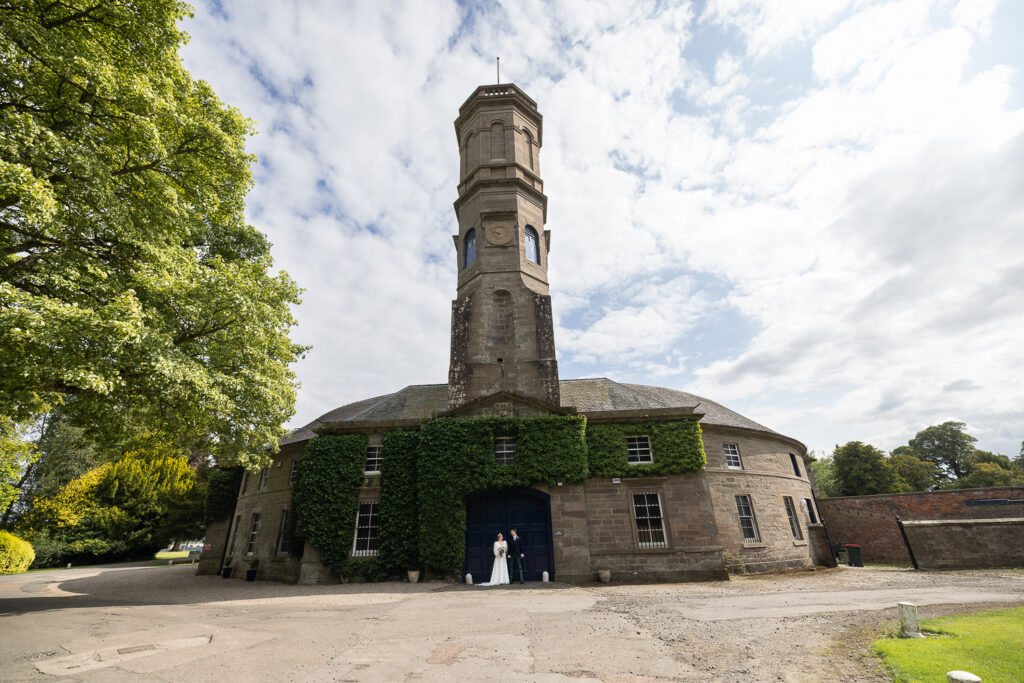 wedding couple portrait under the clock tower at errol park
