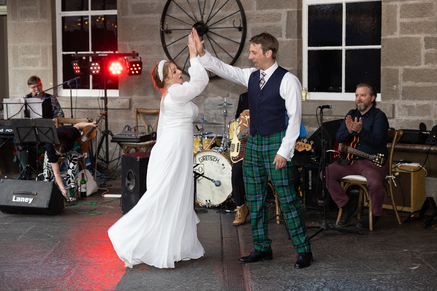bride and groom high-five at first dance