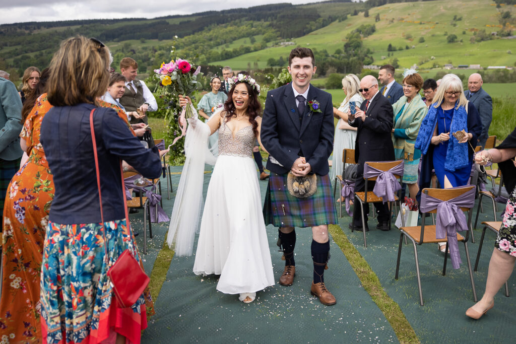 confetti throw with the couple walking back up the aisle after the wedding ceremony