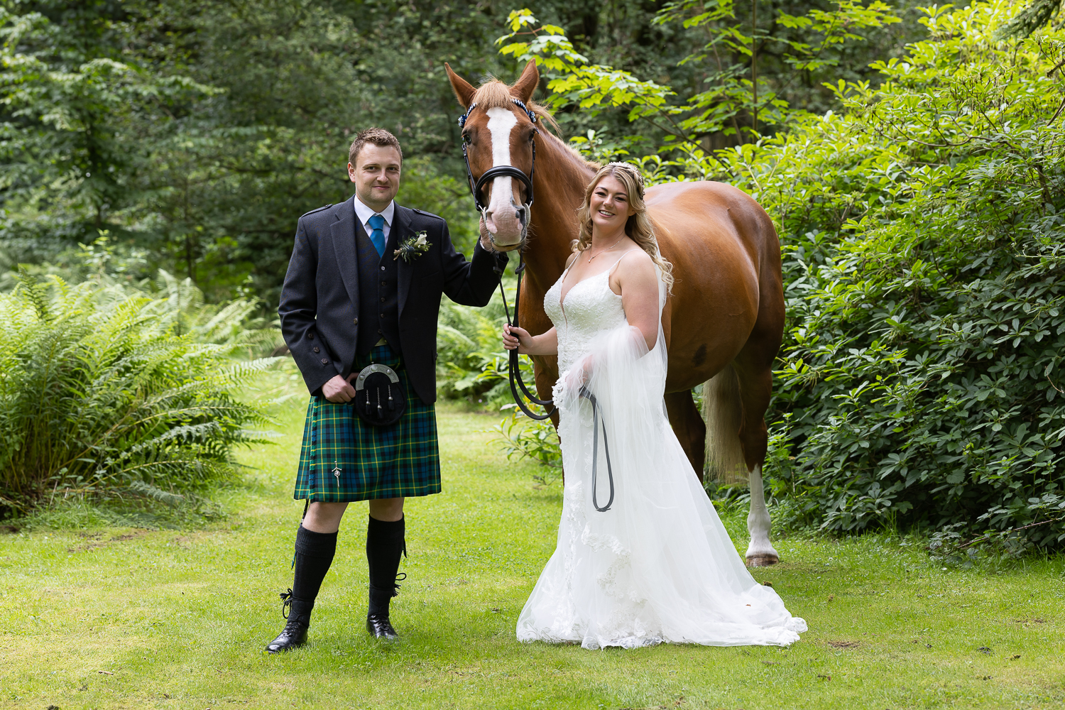couple portrait with their horse in the woods