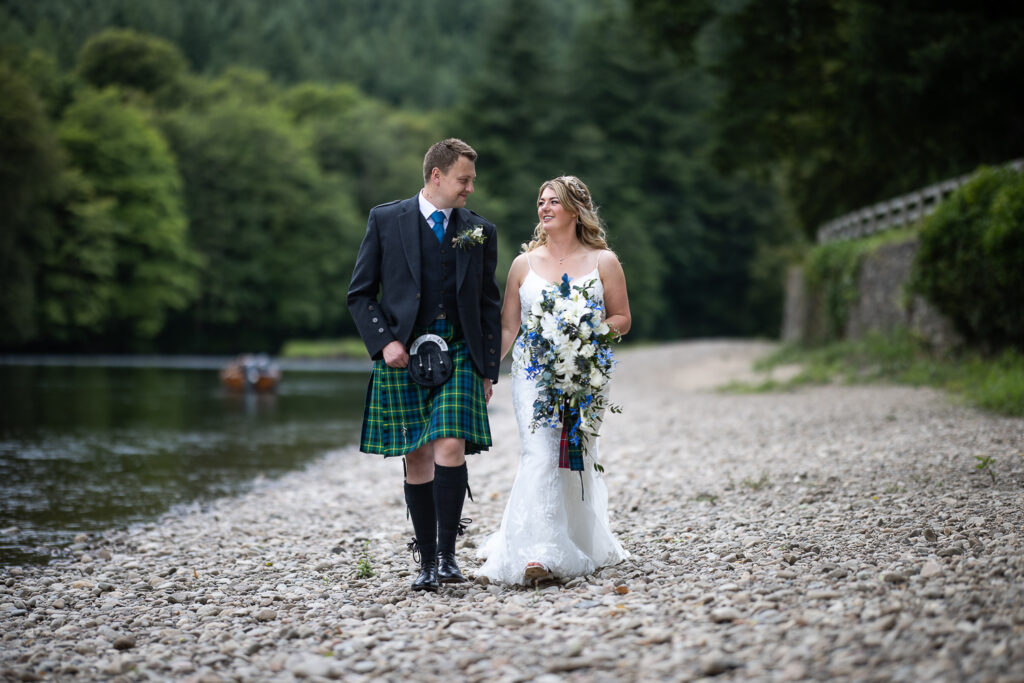 couple portrait walking next to the river