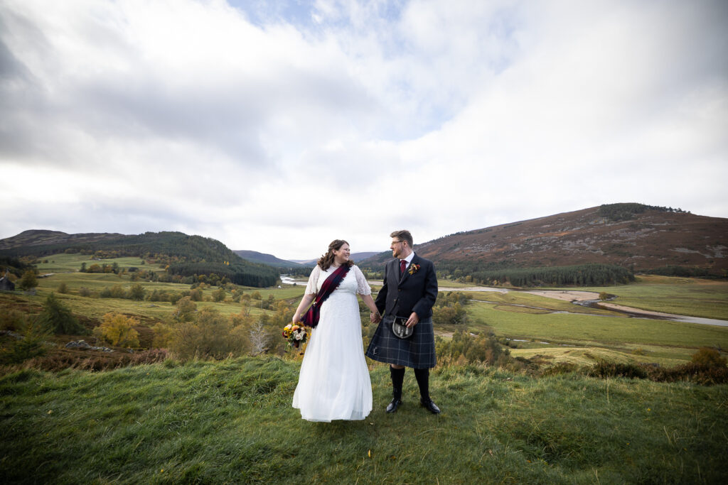 couple portrait of bride & groom at Mar Lodge with mountains in the background