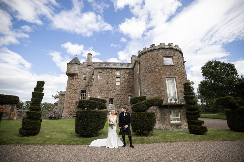 bride & groom portrait against Megginch Castle