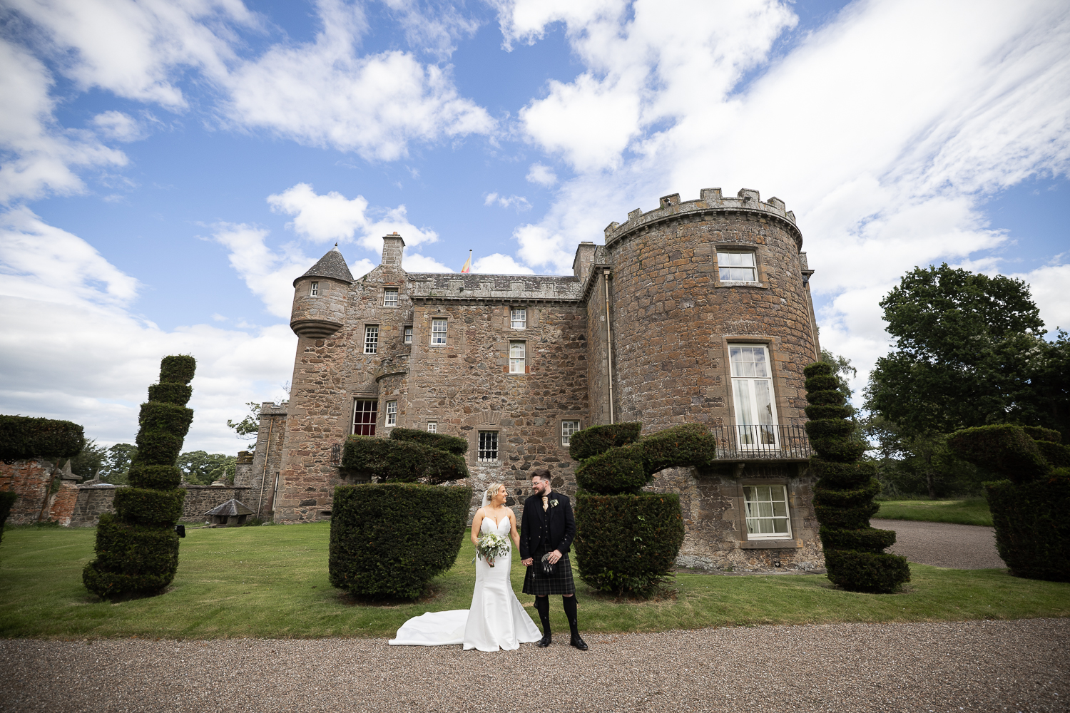 bride & groom portrait against Megginch Castle