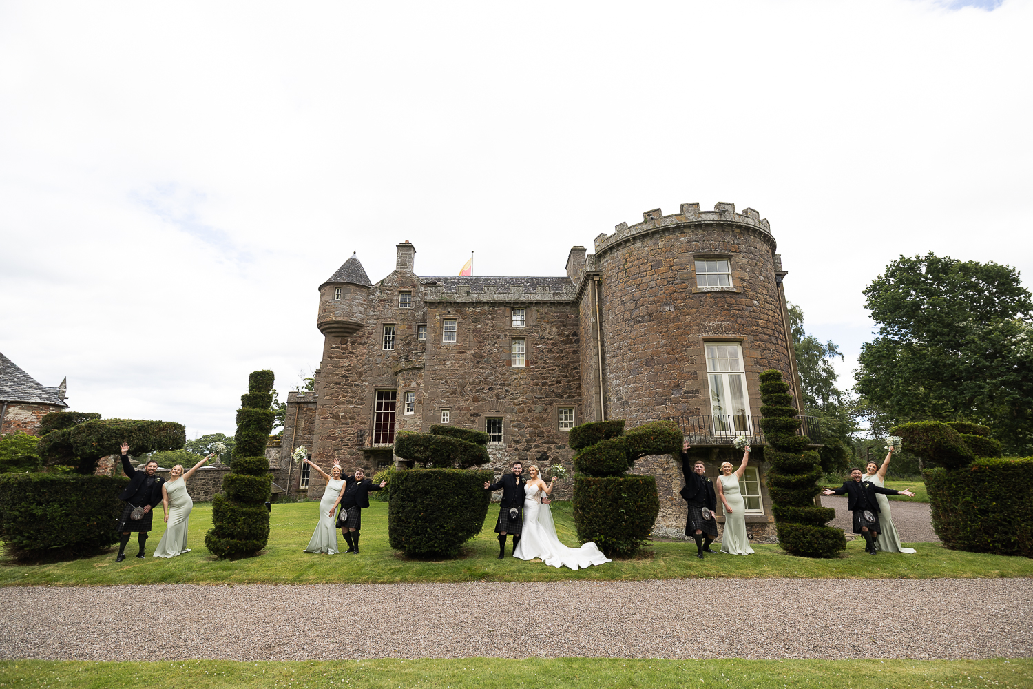 4 couples in between bushes in front of Megginch Castle